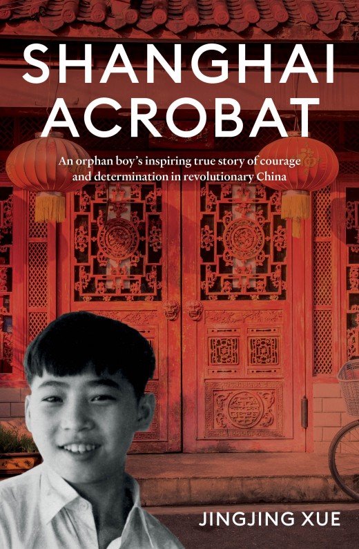 Black and white photograph of a young boy in front of an image of red carved doors leading to Chinese building